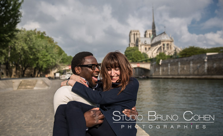 portrait couple in love smile happy emotion front of notre dame cathedral in paris emotions