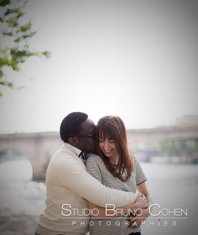portrait kissing couple in love from quai de seine in paris near Eiffel Tower emotions kiss 