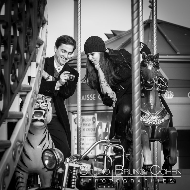 couple in love riding on horse from carousel Eiffel Tower proposal in paris black and white