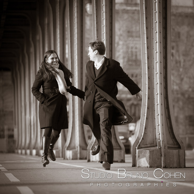 portrait jumping couple in love from bir hakeim bridge near Eiffel Tower smile happy emotions