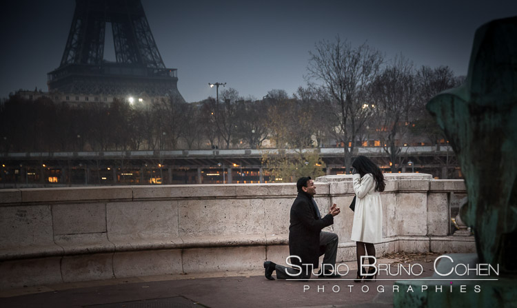 surprise proposal in paris couple in love emotions happy smile cry front Eiffel Tower at night winter