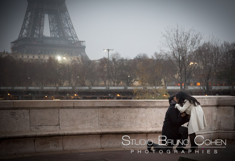 surprise proposal in paris couple in love emotions happy smile cry front Eiffel Tower at night winter kiss