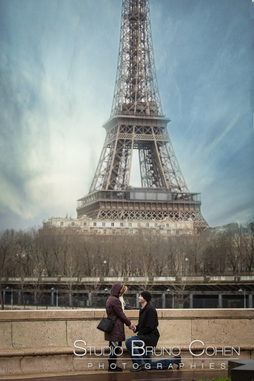 surprise proposal in paris valentine day front of Eiffel Tower blue sky winter couple in love smile happy