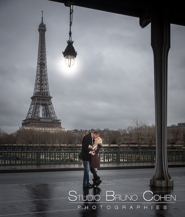 portrait kissing couple stand from bir hakeim bridge front of Eiffel Tower at winter valentine day 
