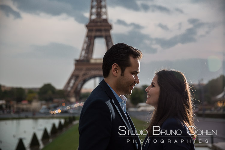 portrait couple face to face in love from Trocadero front of Eiffel Tower in paris sunlight 
