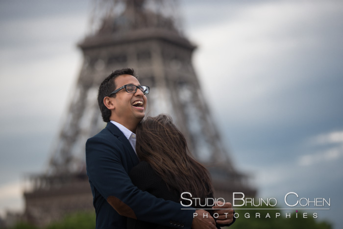 couple hugging front of Eiffel Tower proposal in paris 