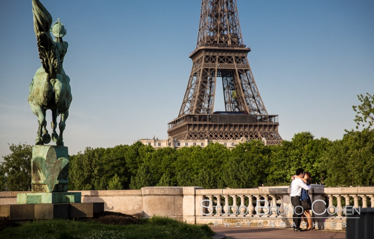 proposal in paris couple hugging in love from Bir Hakeim bridge front of Eiffel Tower at sunrise