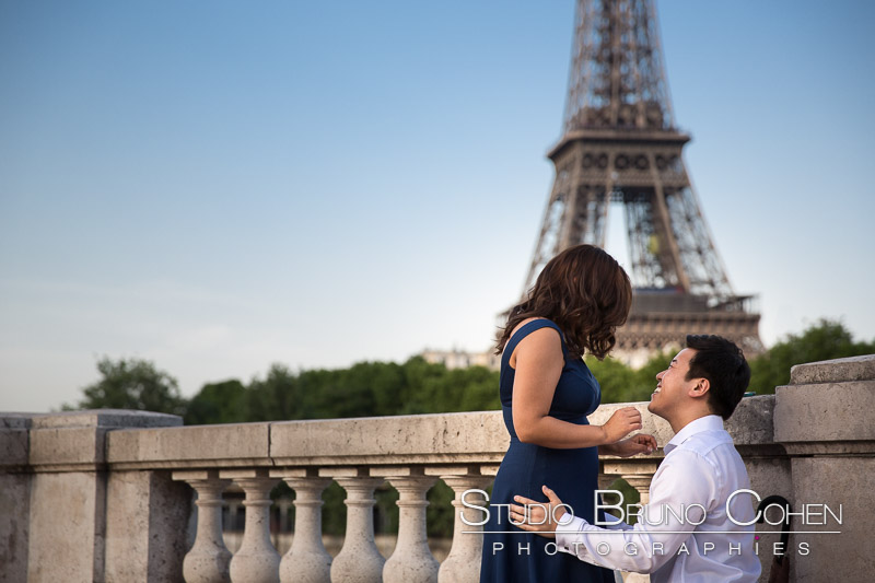 proposal in paris couple emotions in love cry lady asian from bir Hakeim bridge front of Eiffel Tower at sunrise 