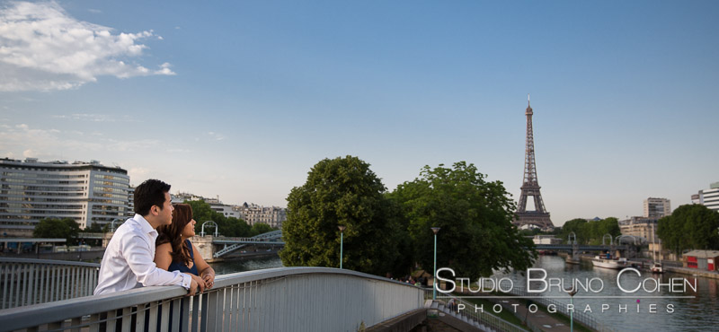 amazing portrait couple in love from paris front of Eiffel Tower blue sky at sunrise 