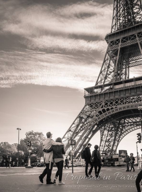 couple in love front of eiffel tower black and white proposal in paris