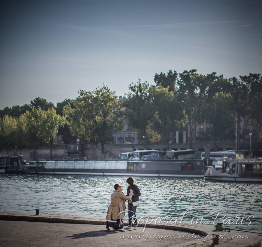 surprise proposal in paris from quai de seine front of eiffel tower 