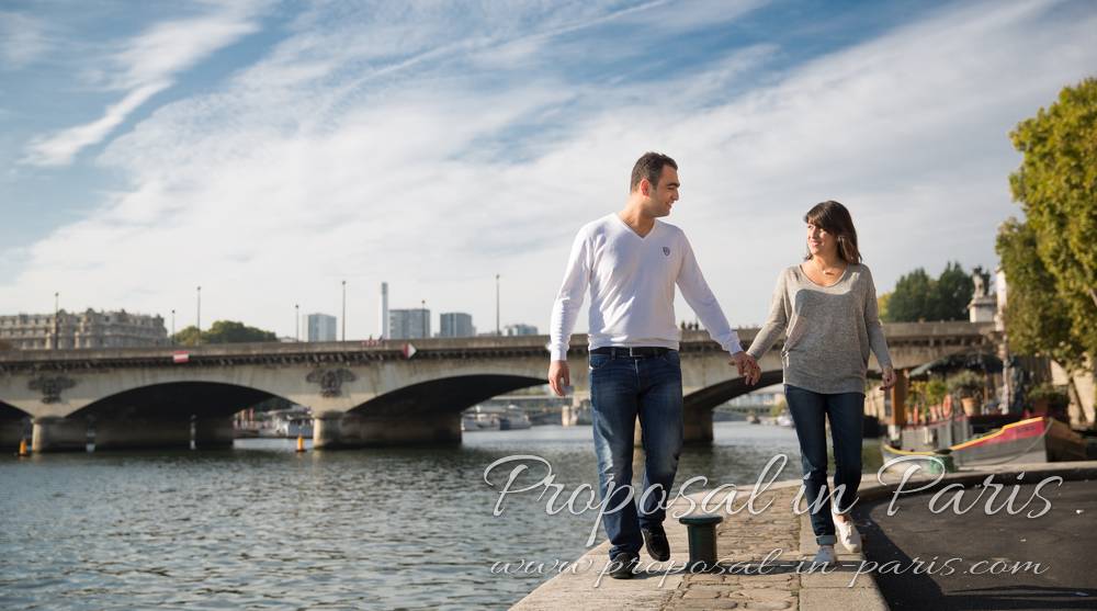 couple walk in quai de seine at paris near eiffel tower proposal surprise engagement session