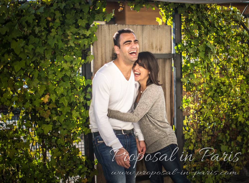 smiling couple in love from quai de seine in paris near eiffel tower engagement session