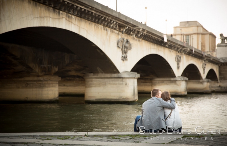 hugging couple from quai de seine near eiffel tower at paris