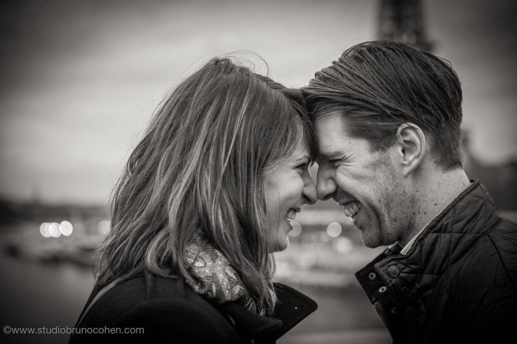 portrait couple forehead against forehead smile love happy black and white in paris engagement session proposal