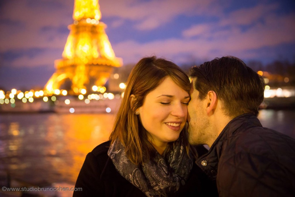 portrait couple in love closer front of Eiffel Tower at sunset winter night proposal in paris engagement session 