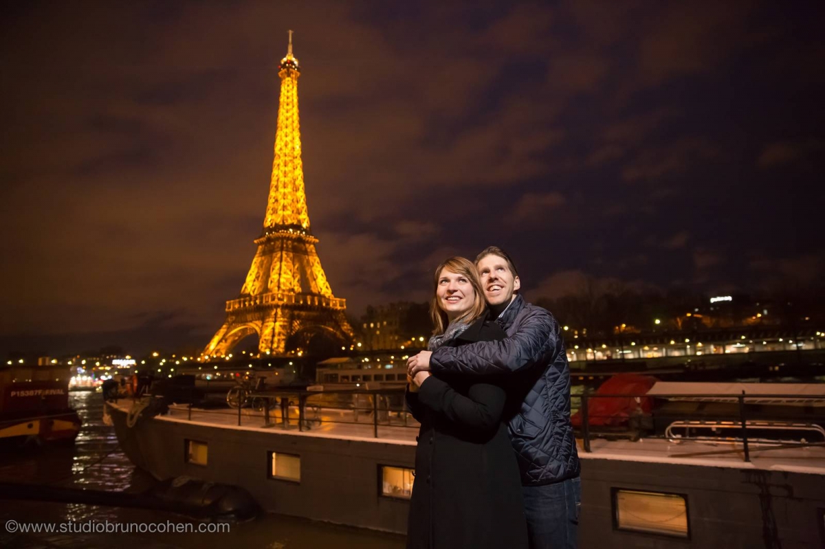 amazing portrait couple in love from paris front of Eiffel Tower at night winter