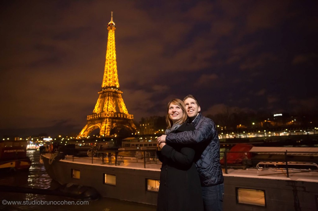 amazing portrait couple in love from paris front of Eiffel Tower at night winter 