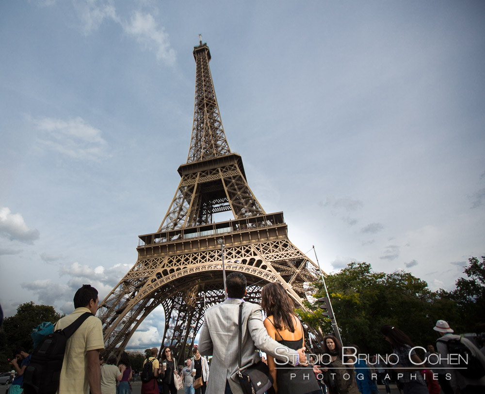 couple in love from paris front of eiffel tower proposal surprise