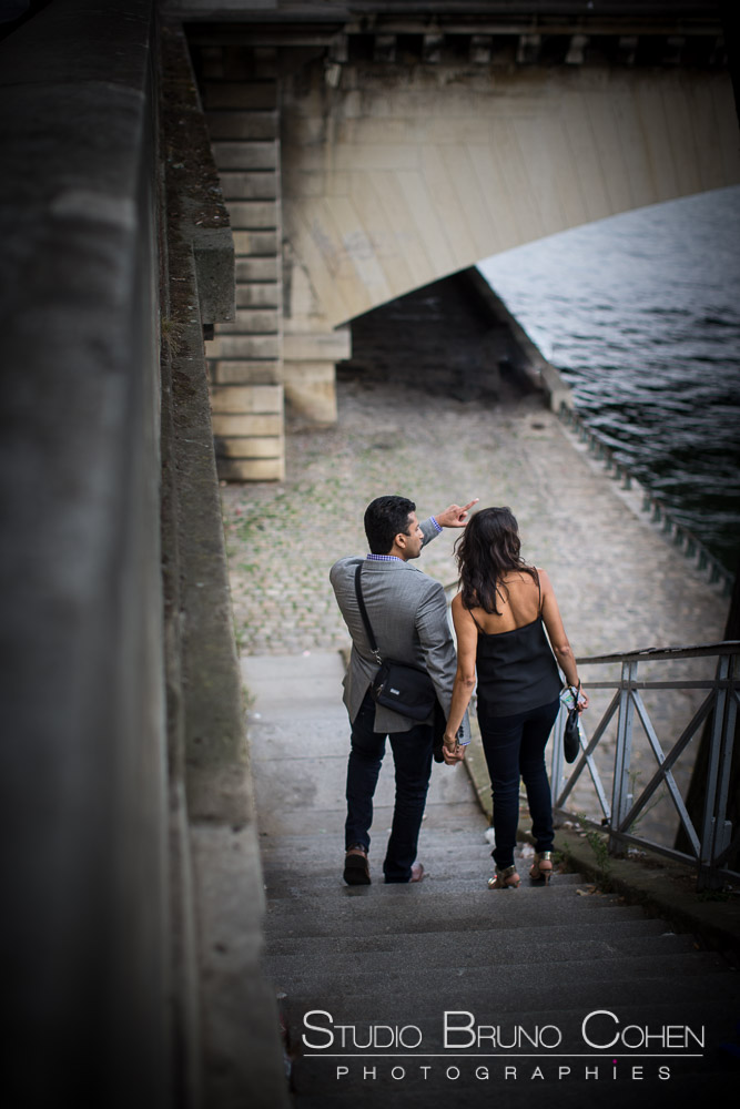 proposal in paris couple in love from quai de seine near eiffel tower at summer