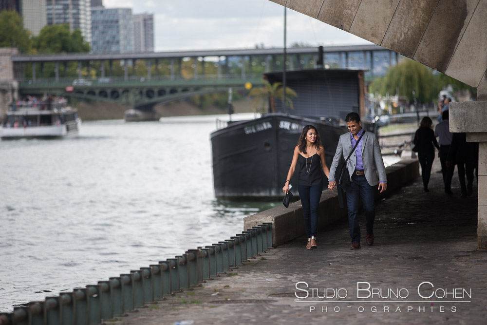 couple walk in quai de seine at paris near eiffel tower proposal surprise engagement session