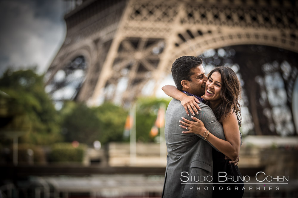 couple happy in paris hugs love proposal front of eiffel tower