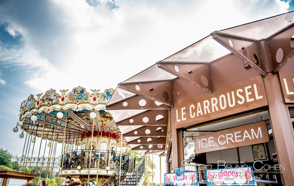 proposal in paris eiffel tower carousel at summer blue sky