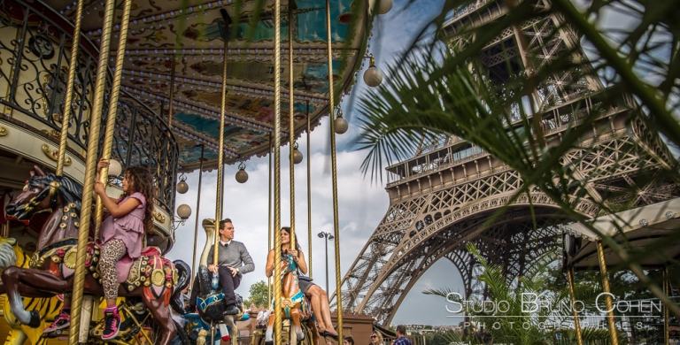 couple riding on horses at eiffel tower carousel proposal in paris summer 