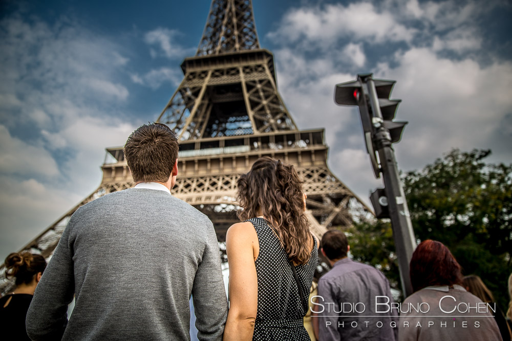 couple ahand in hand front of eiffel tower paris