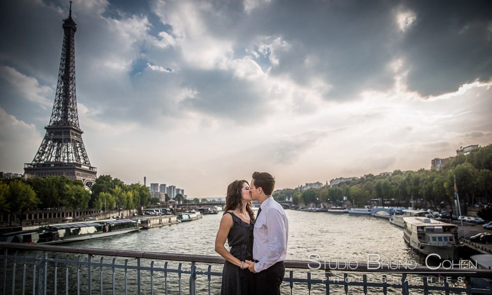portrait kissing couple in paris proposal at summer sunset 