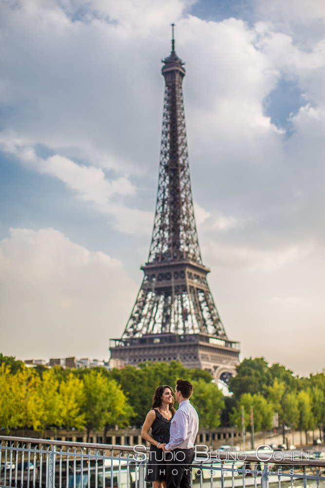 portrait couple in love front of eiffel tower in paris at summer blue sky