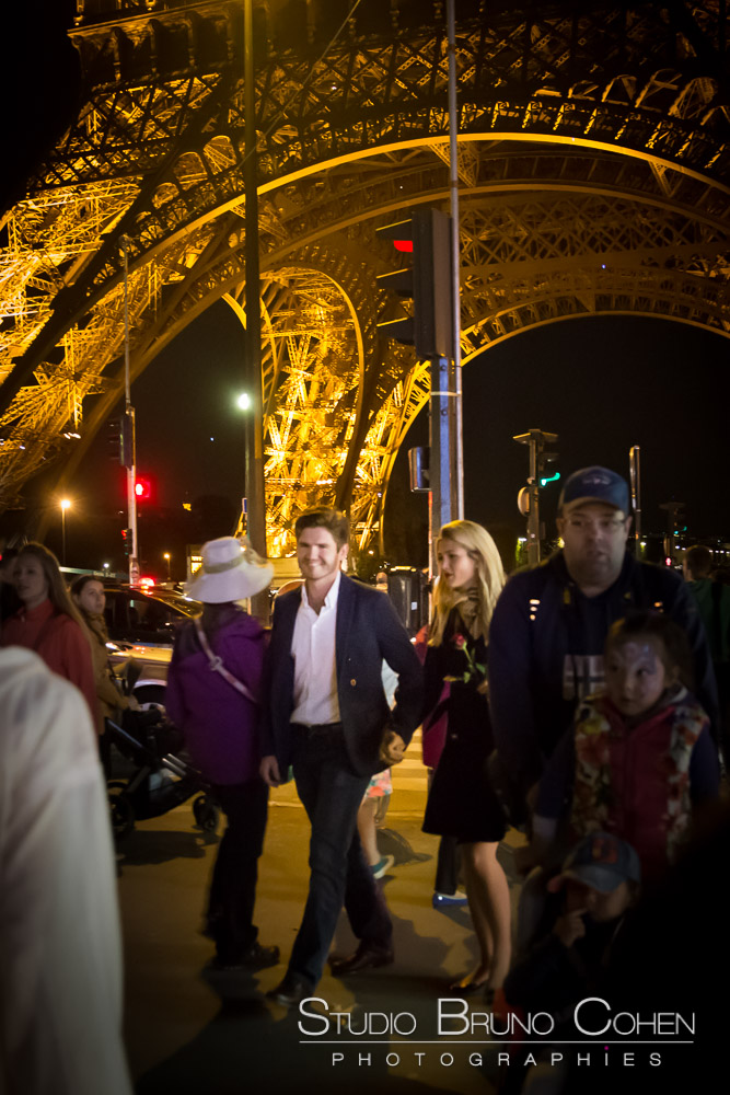 couple in love walk in paris at night front of eiffel tower 