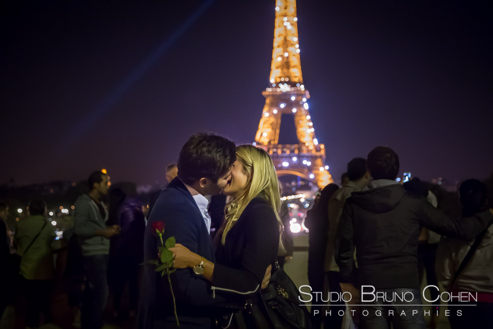 eiffel tower sparkles at night proposal in paris couple kiss from trocadero
