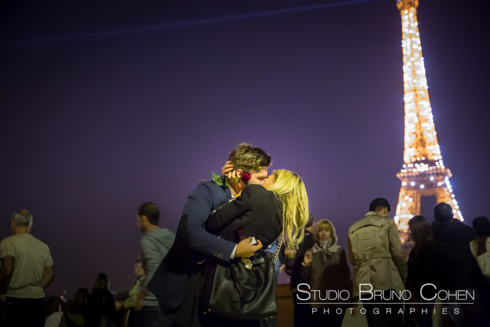 eiffel tower sparkles at night proposal in paris kissing couple from trocadero