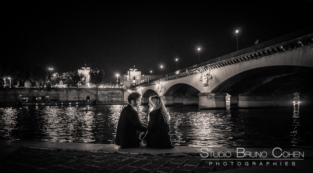 portrait couple face to face in paris from quai de seine front of eiffel tower at night black and white