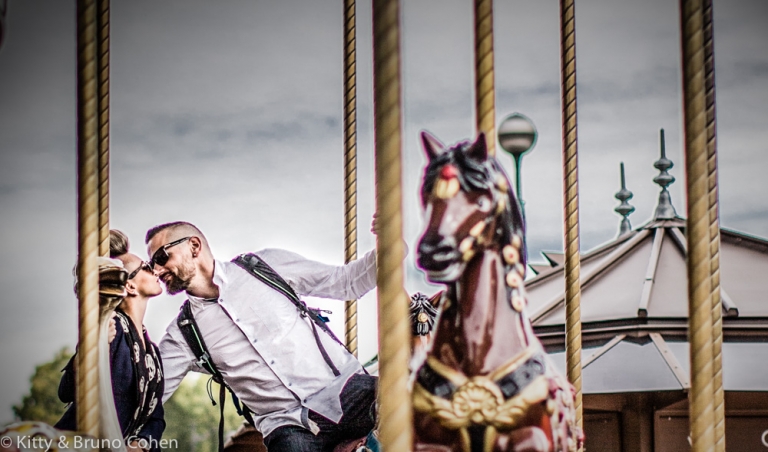 kissing couple on horses from eiffel tower carousel proposal in paris