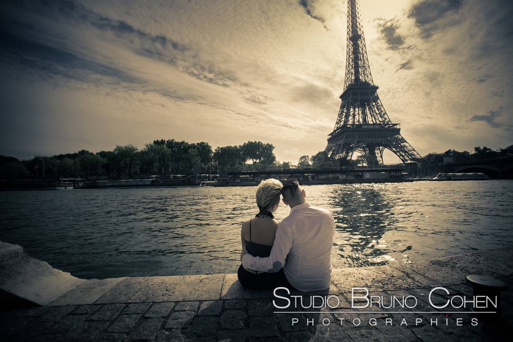 hugging couple in love front of eiffel tower in paris 