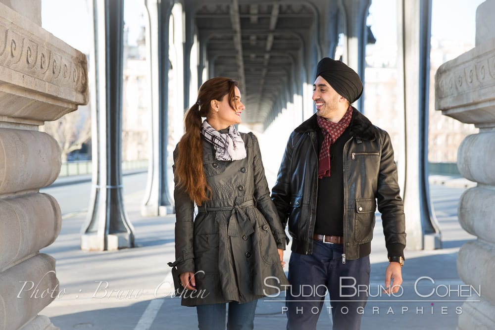 couple in love under Bir Hakeim bridge smile love from paris