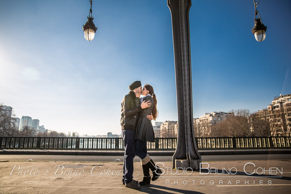 kissing couple under kir Hakeim bridge in paris at winter blue sky love proposal