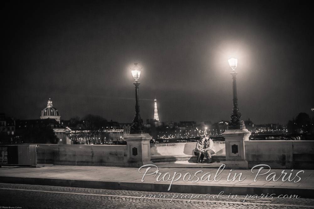 couple kissing on a stone bench, Pont-Neuf, Paris,black and white by night
