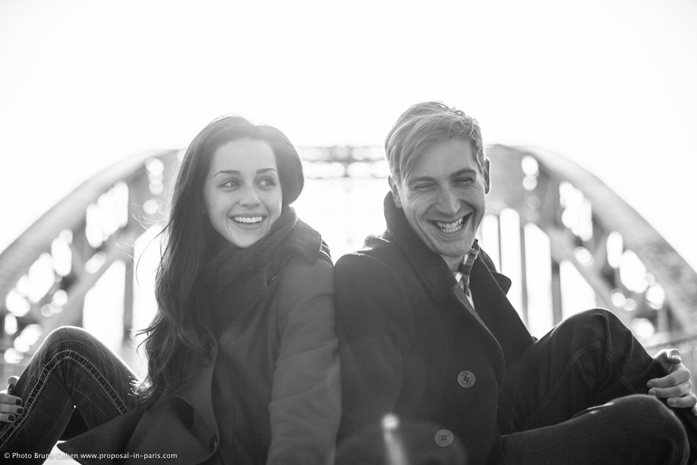 engagement photographer Paris couple in love on Passerelle Debilly black and white 