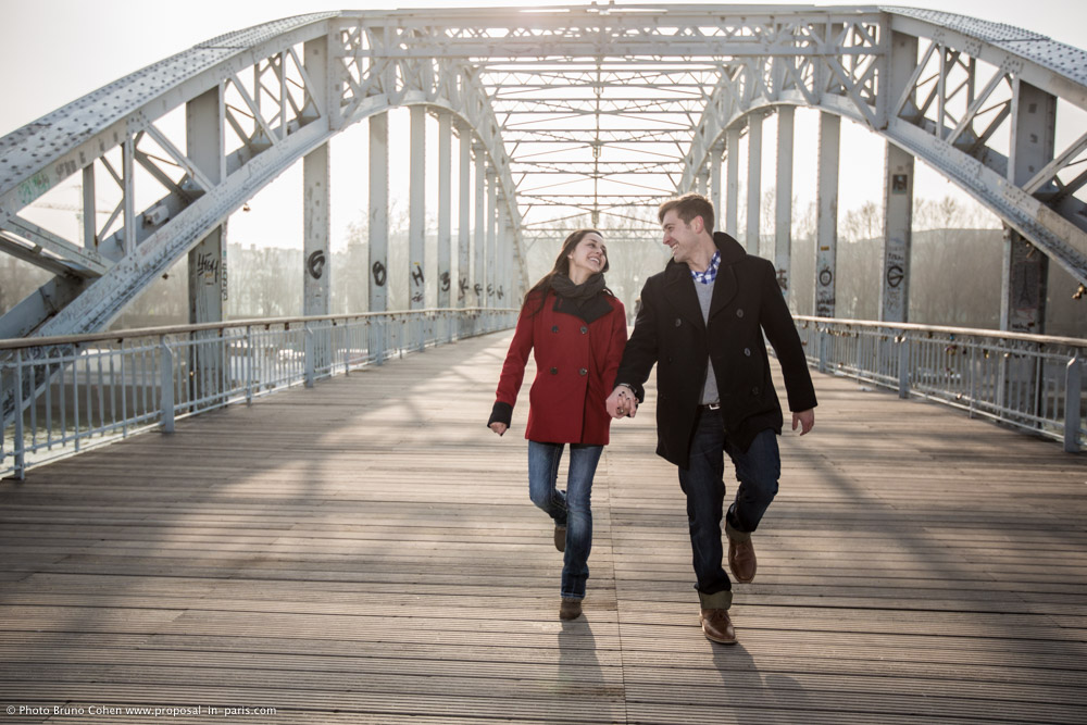 engagement photographer couple walk dewily passerelle proposal in paris at sunrise 