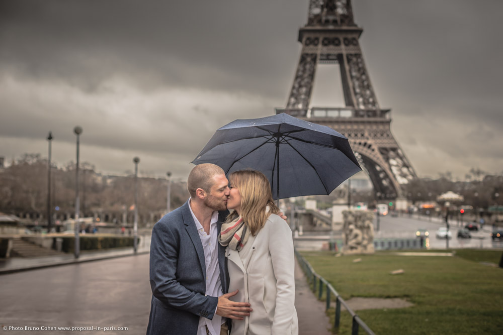 portrait kissing couple in love from Trocadero square front of Eiffel Tower proposal at winter morning emotions kiss
