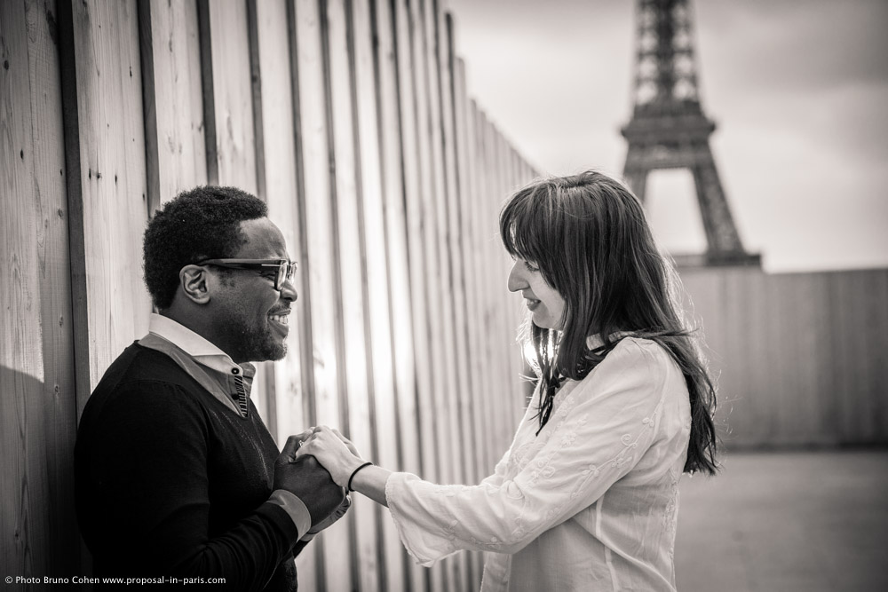 engagement session couple face to face in love hugs from Trocadero front of Eiffel Tower in paris black and white