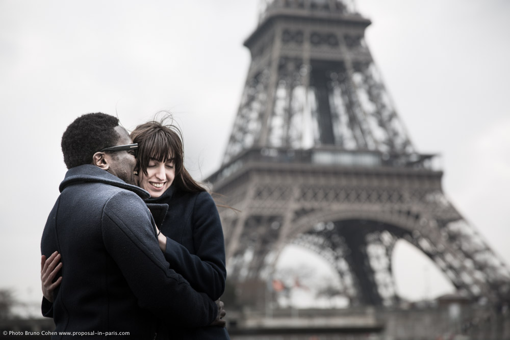 Beloved photographer paris hugging couple in love front Eiffel Tower Trocadero place
