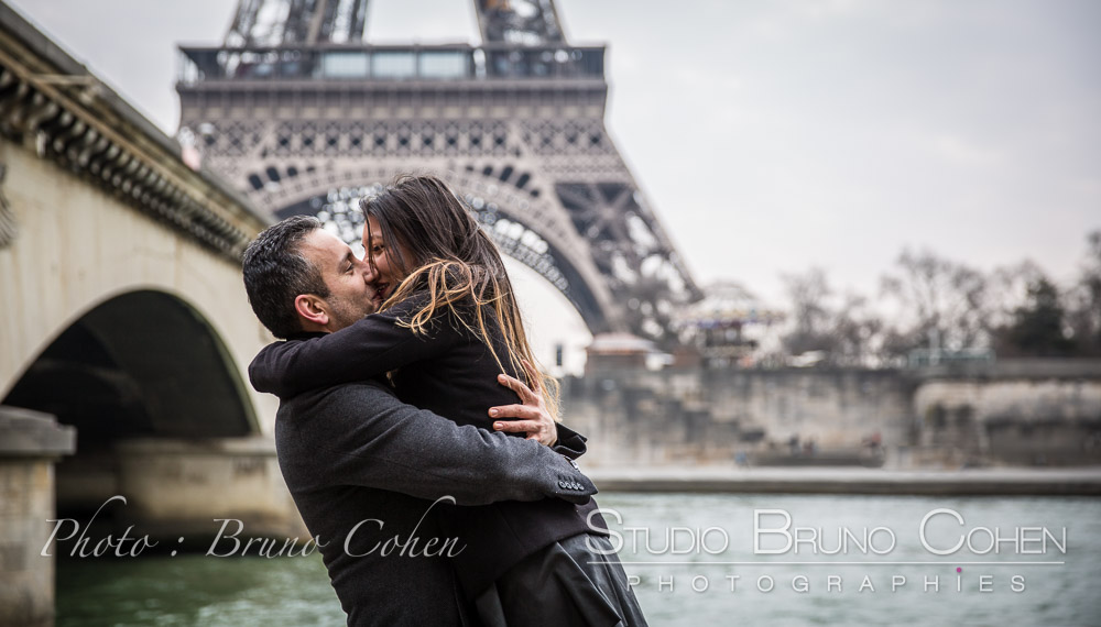 proposal in  paris kissing couple from seine banks near Pont d'Iena front of Eiffel Tower 
