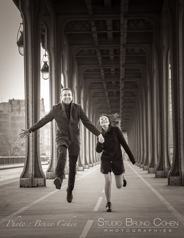 Engagement session from Bir-Hakeim bridge jumping couple in love happy black and white
