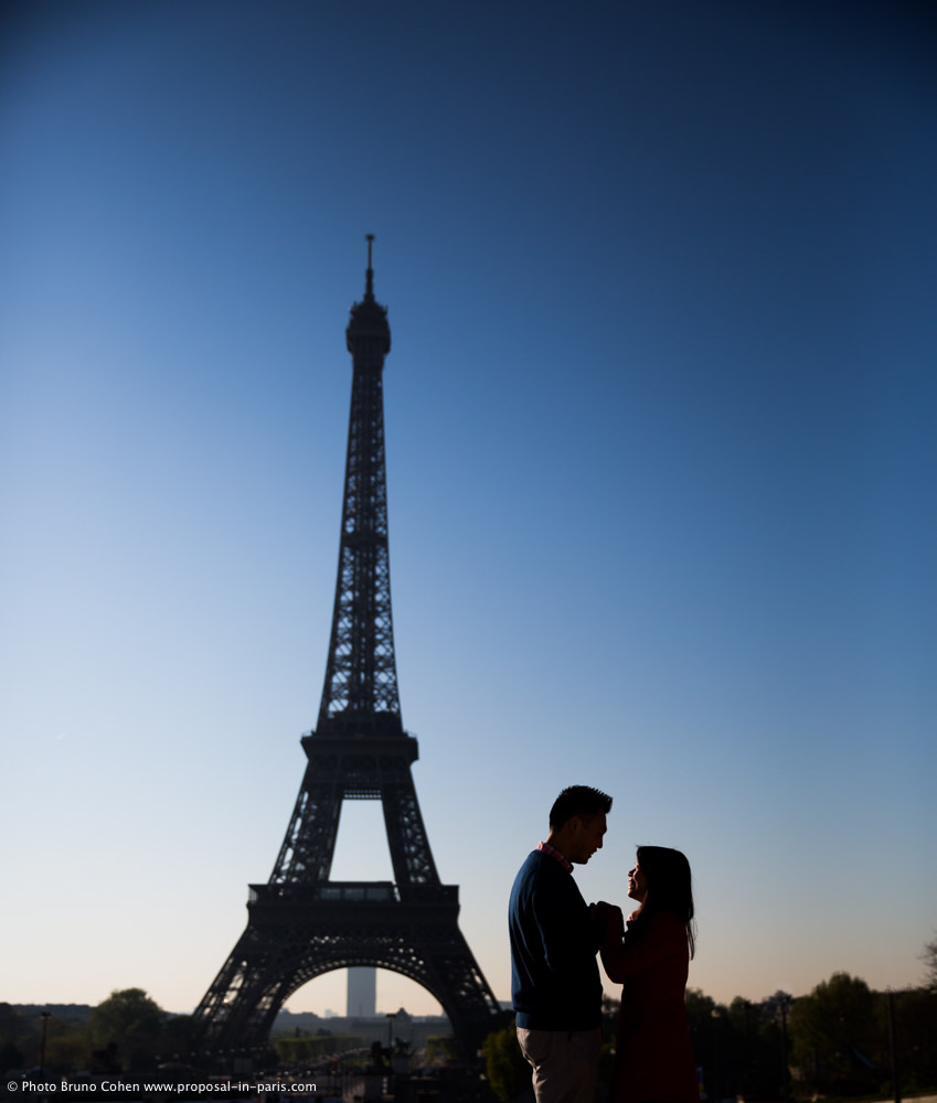 couple in love face to face from Trocadero front of Eiffel Tower paris at sunrise