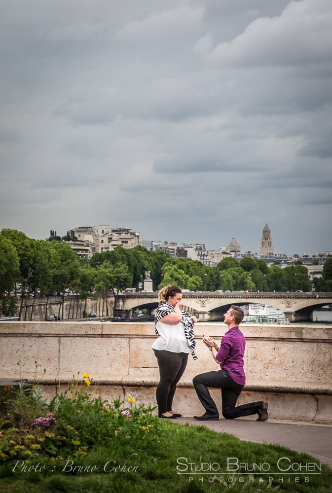 lady crying during a surprise proposal in paris at Bir Hakeim bridge