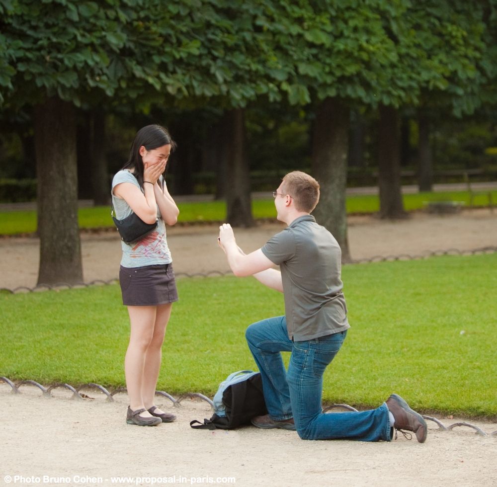 proposal in Luxembourg gardens in paris couple love ring engagement